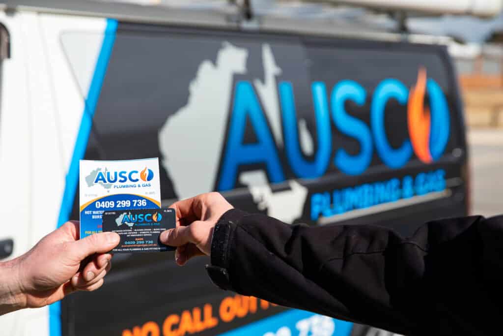 Ausco Plumbing & Gas stationery exchanging hands