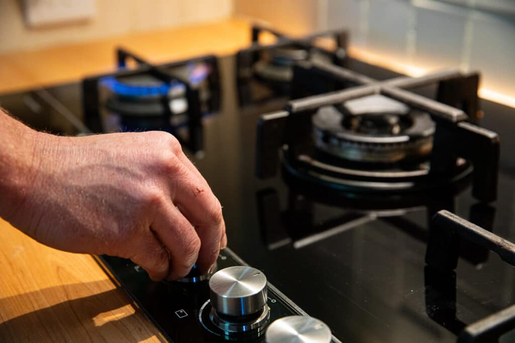 A man testing a gas stove