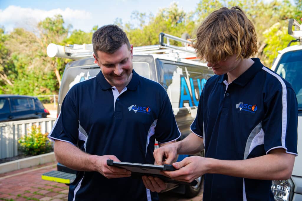 Ausco Plumbing & Gas team looking at a tablet