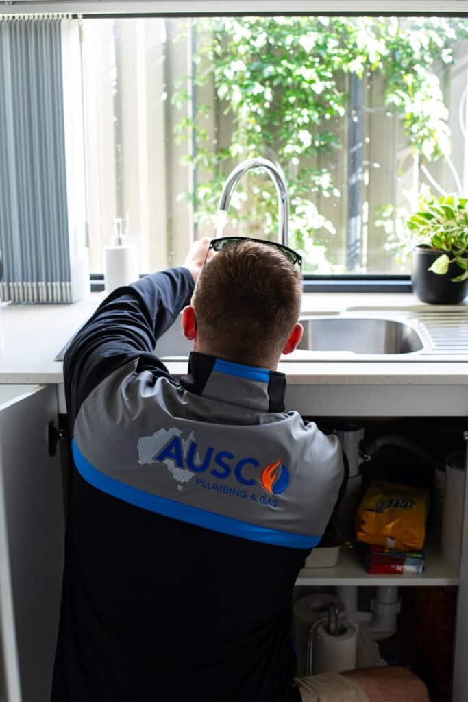 Ausco Plumbing & Gas team testing a kitchen tap