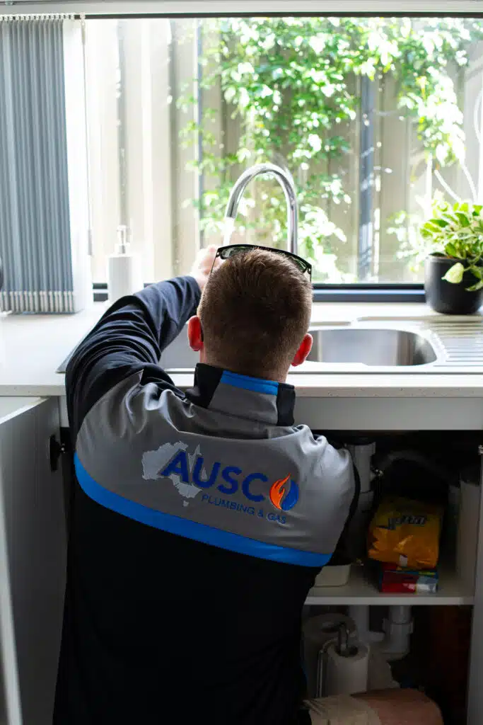 Ausco Plumbing & Gas team testing a kitchen tap