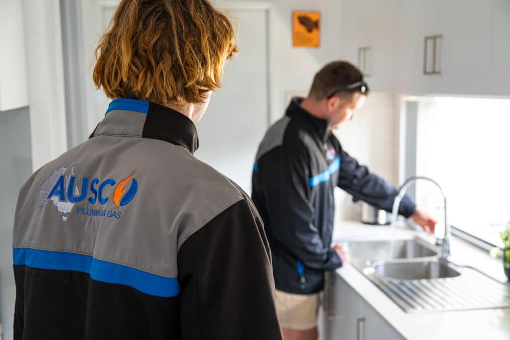 Ausco Plumbing & Gas team testing a kitchen tap