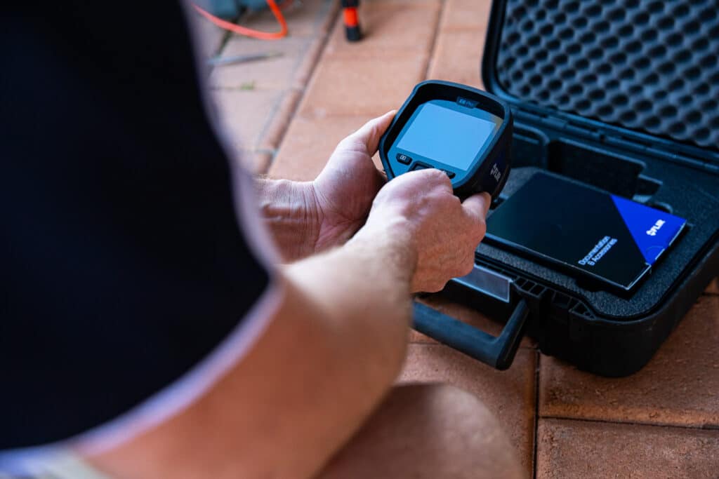 A man holding an E6 Pro thermal imaging tool